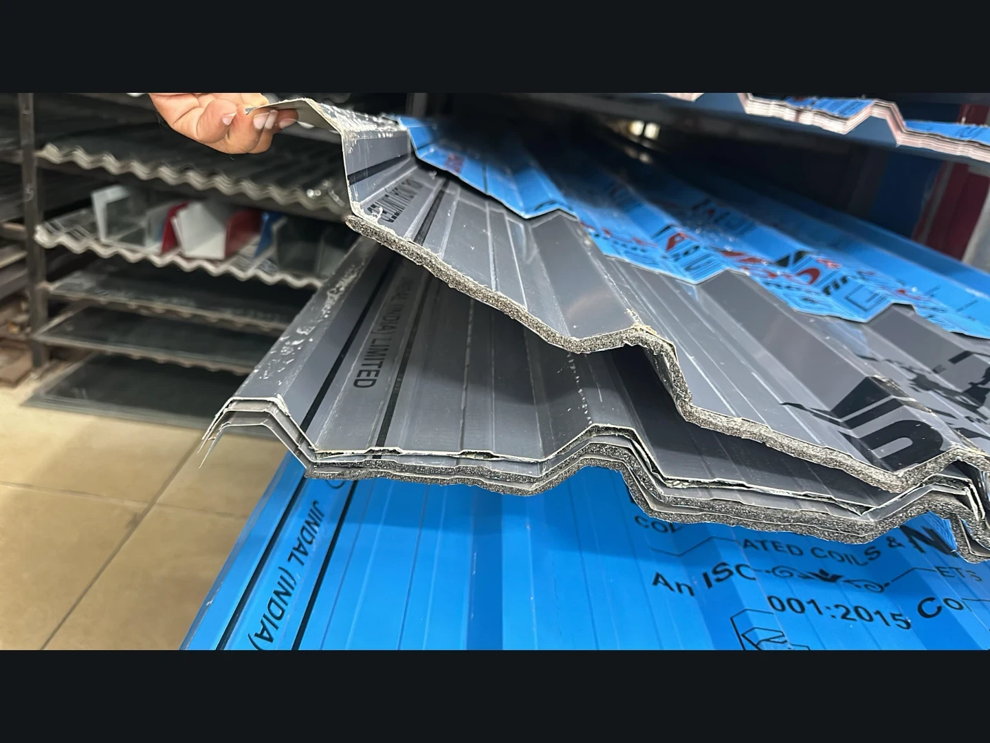 Insulated colour-coated roofing sheet profile with thermal backing